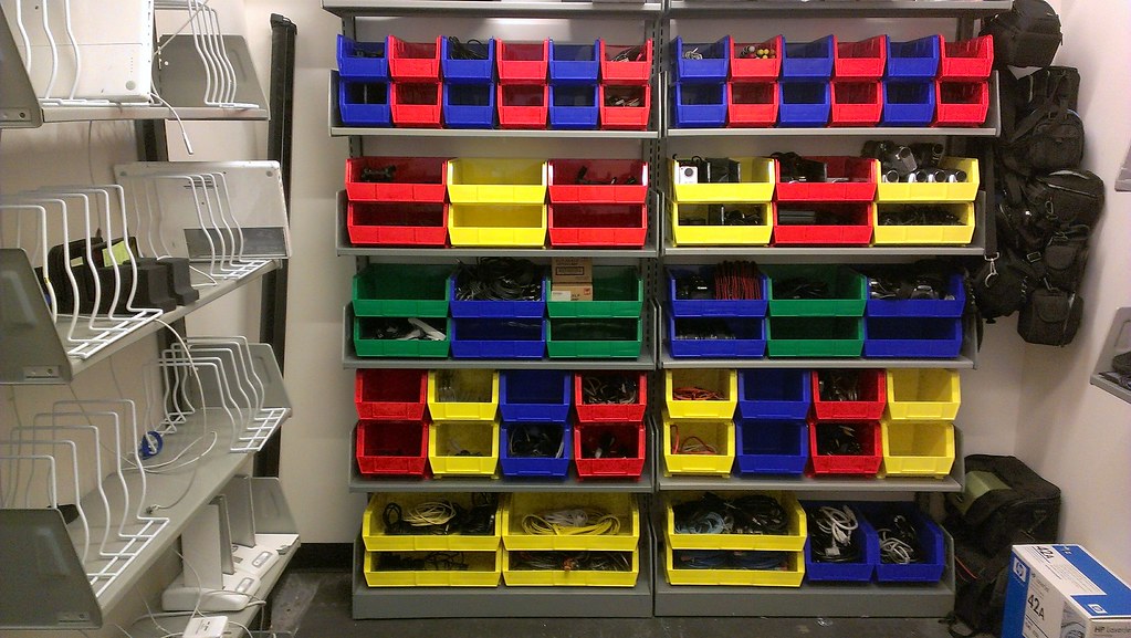 Colorful storage bins arranged on metal shelves