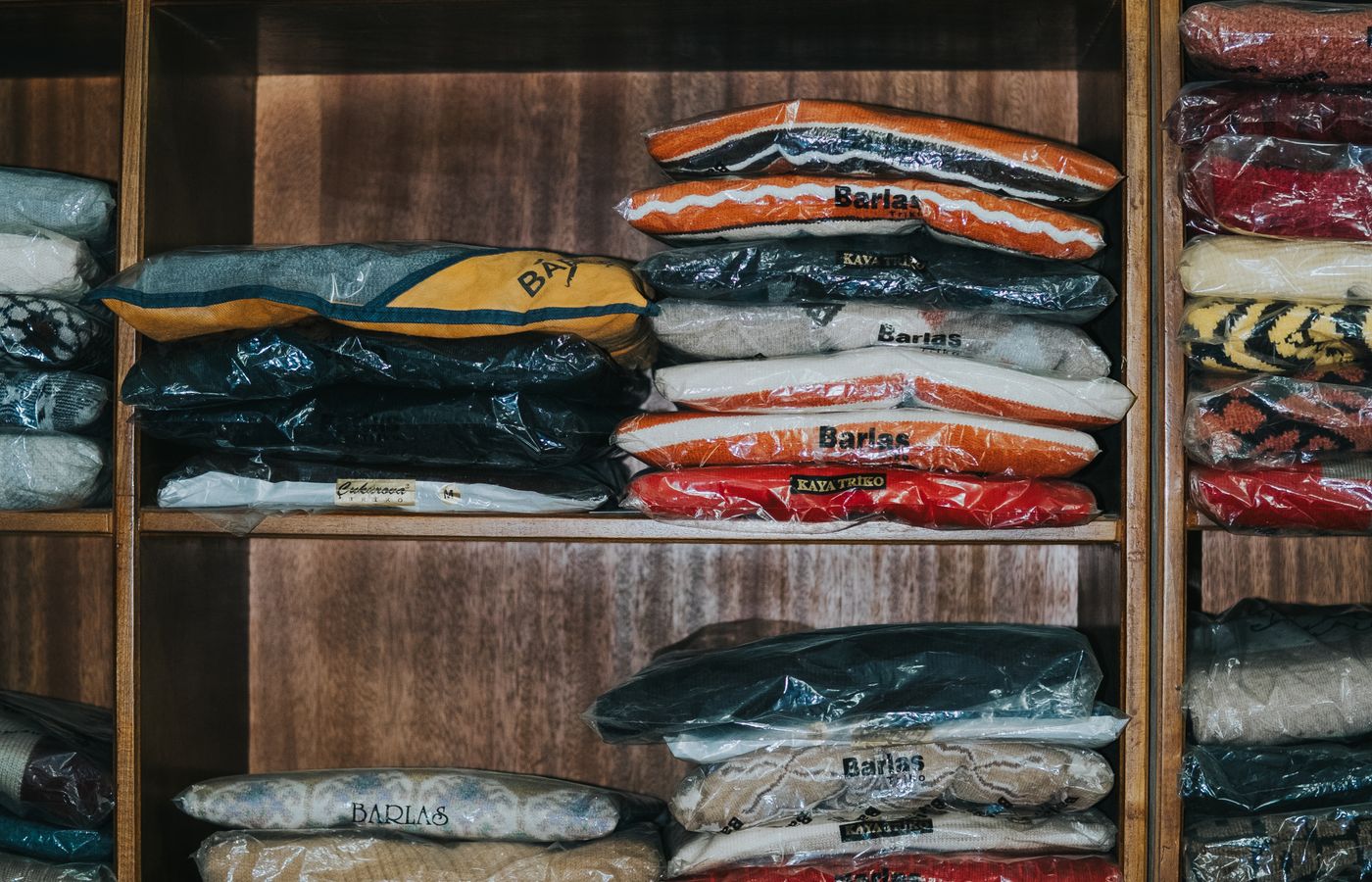 Folded clothes arranged neatly on compact shelves to reduce visible clutter