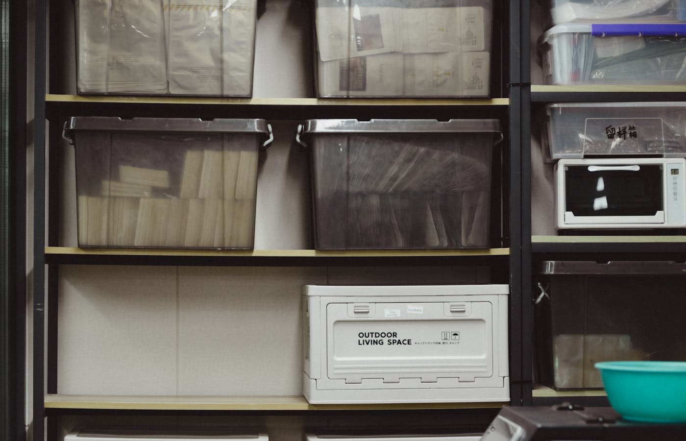 Storage shelves with labeled bins and boxes in a small home storage area