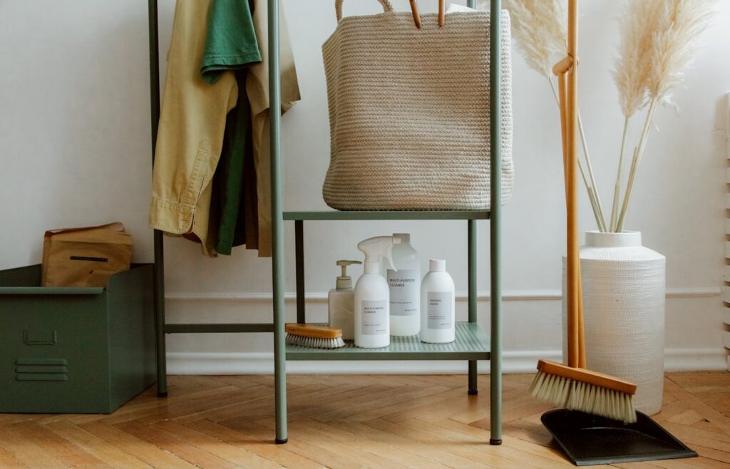 Cleaning products and a bag lying on metal shelves