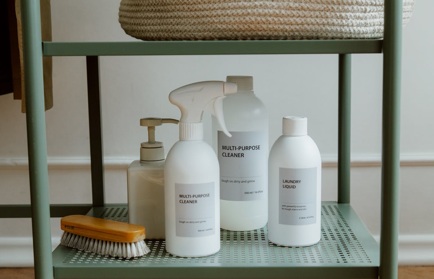 Bottles of cleaning products standing on a metal shelf