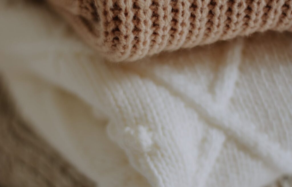 Folded seasonal winter clothing sweaters stacked close together