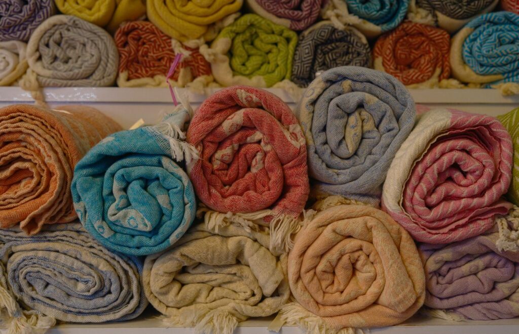 Colorful rolled blankets stacked on shelves