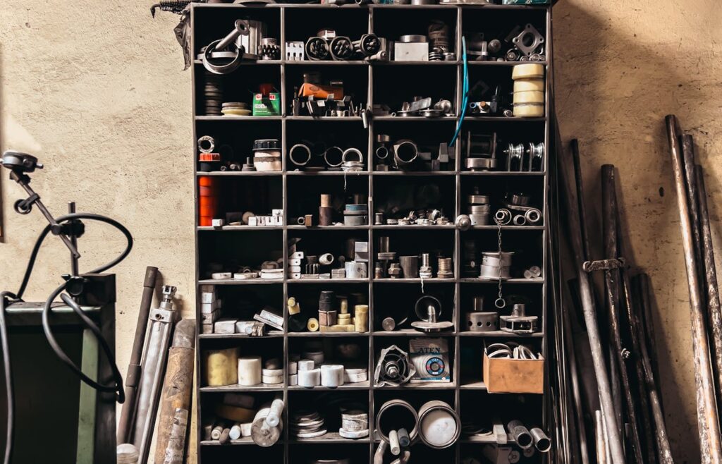 Garage shelf with small parts and tools stored in square cubbies
