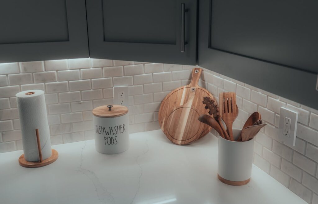 Kitchen counter with a paper towel holder, utensil crock, and wooden boards