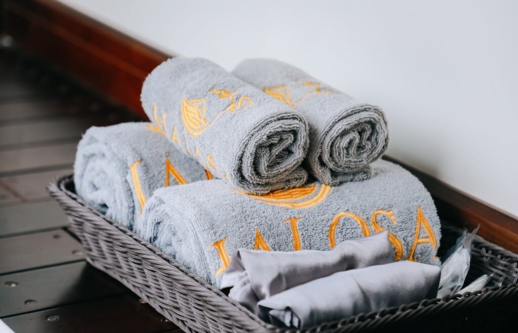 Rolled gray towels arranged in a wicker basket