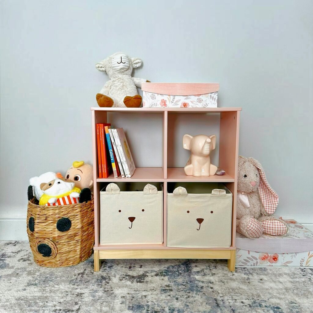 Toy shelf with books stuffed animals baskets and fabric storage bins