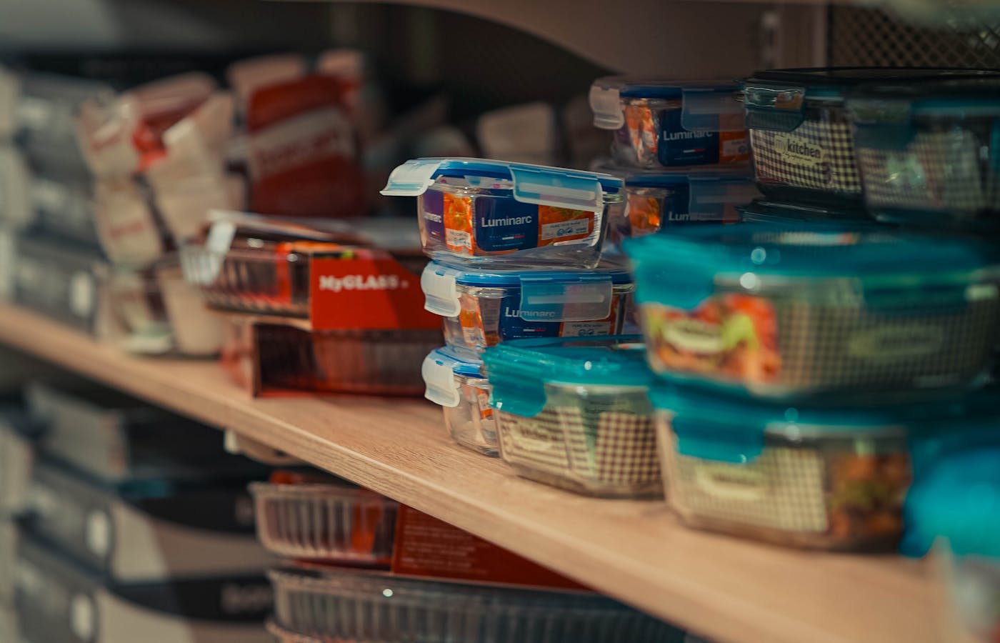 Plastic food storage containers stacked on a store shelf