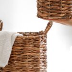 Wicker storage baskets and folded towels in a bright bathroom