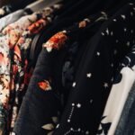 Colorful clothes hanging closely together on a clothing rack