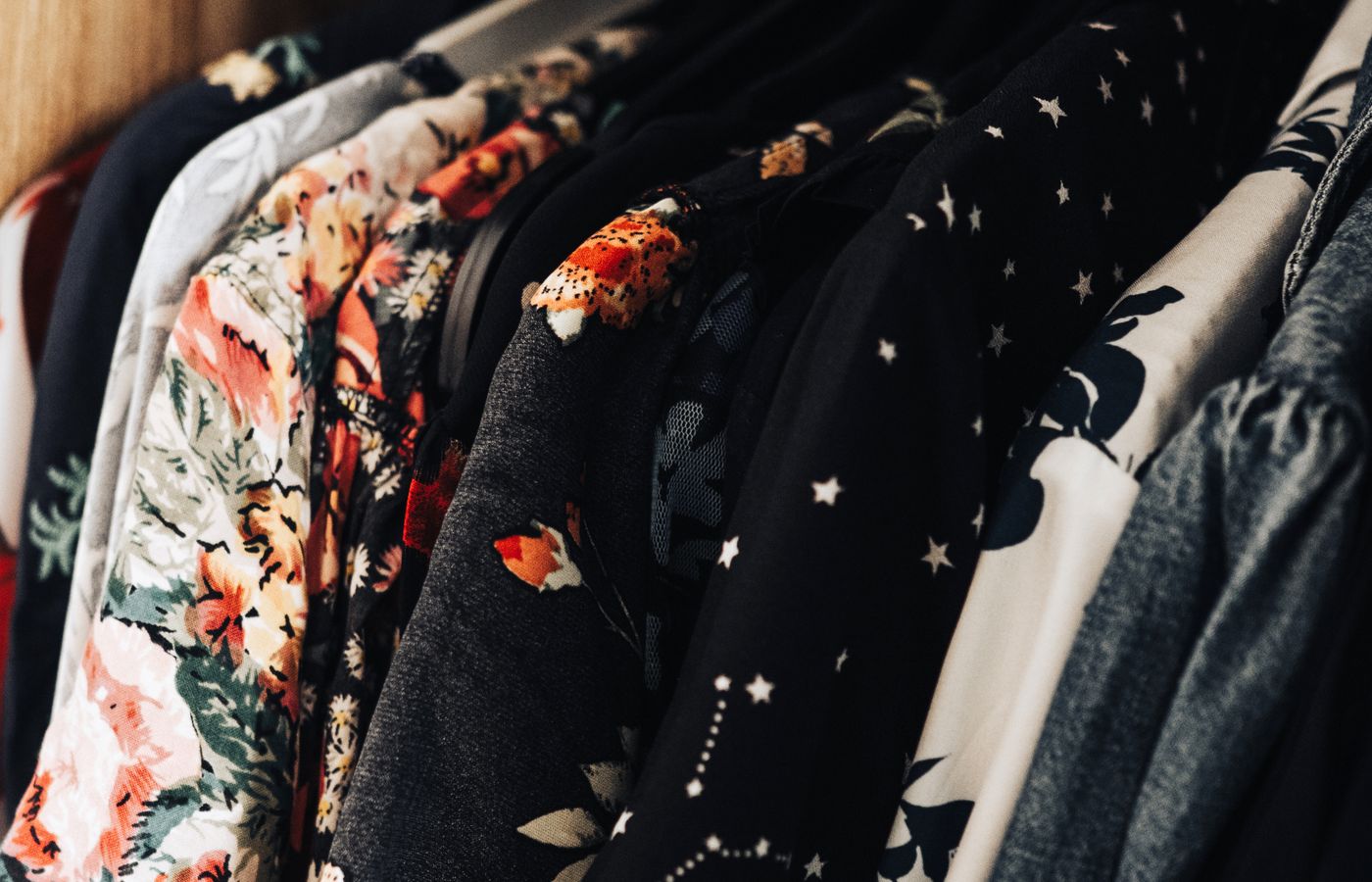 Colorful clothes hanging closely together on a clothing rack