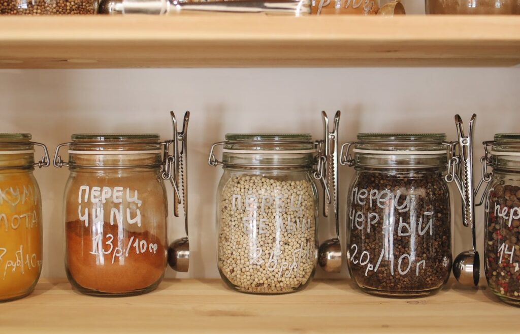Kitchen shelves with labeled glass jars and pantry containers