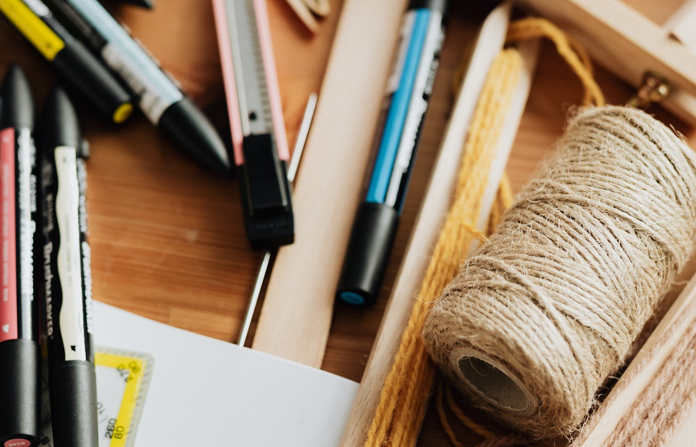 Pens ruler and string stored inside a wooden drawer