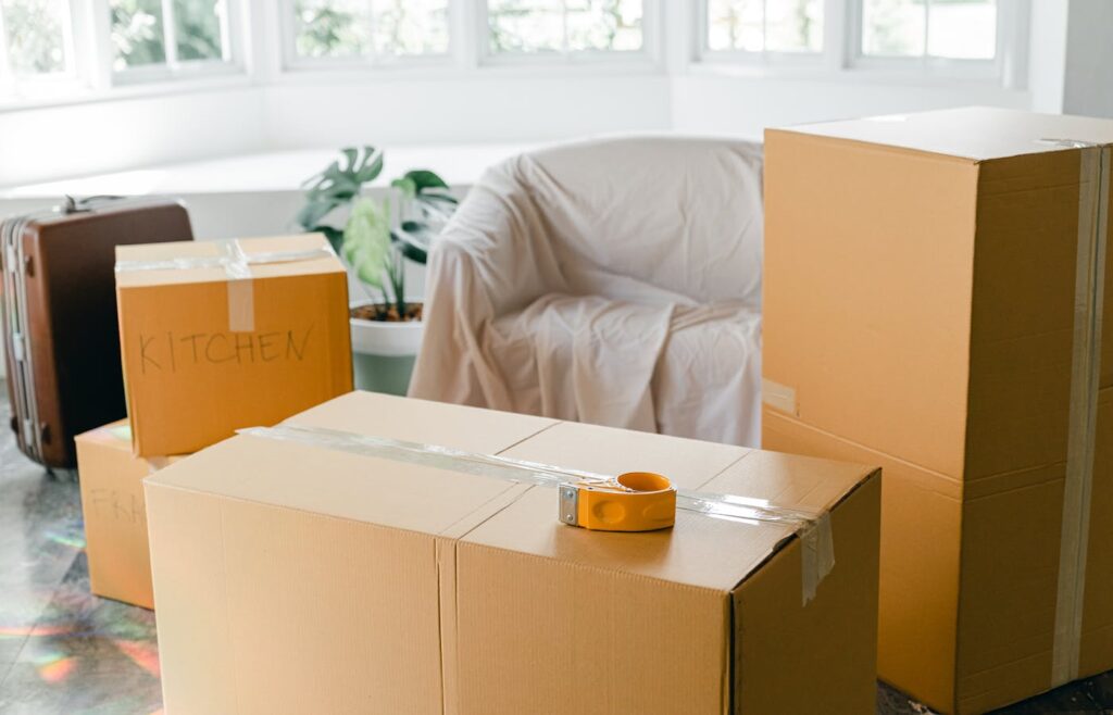 Plastic storage containers and household items on a shelf