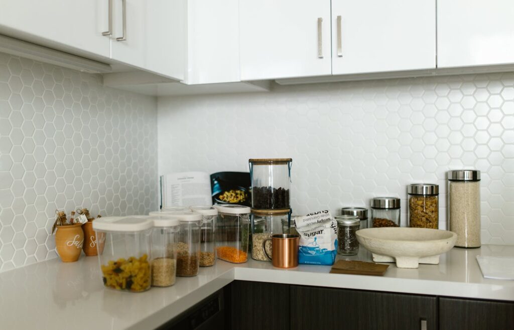 Clear food containers and dry ingredients on a kitchen counter